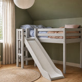 FLEXA High Bed from CLASSIC collection in grey with slide and safety rail in a green child’s bedroom.