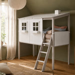 FLEXA MID-HIGH bed with house frame and ladder in white/grey, child-safe design, in a green room with wooden flooring.